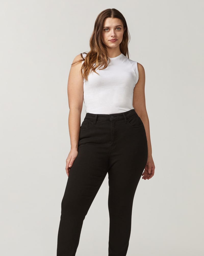 Front of a model wearing a size 14 Madeline High Rise Skinny Jean in Black by Warp + Weft. | dia_product_style_image_id:232663